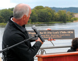 John Bouquest desplays a sign
